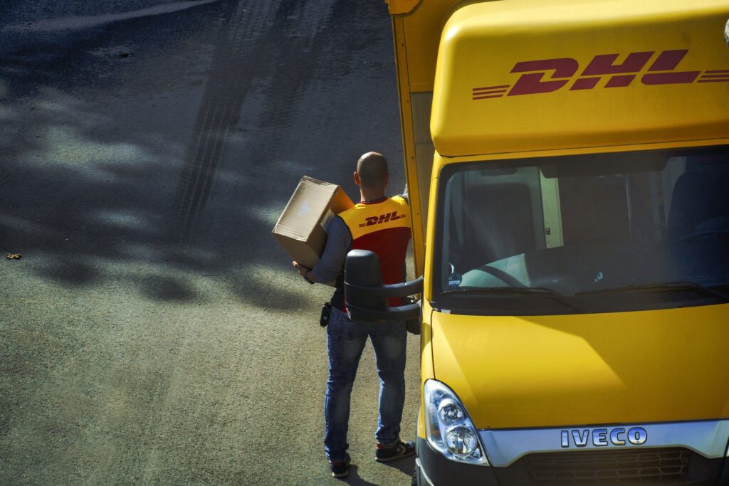DHL delivery person handing over a package